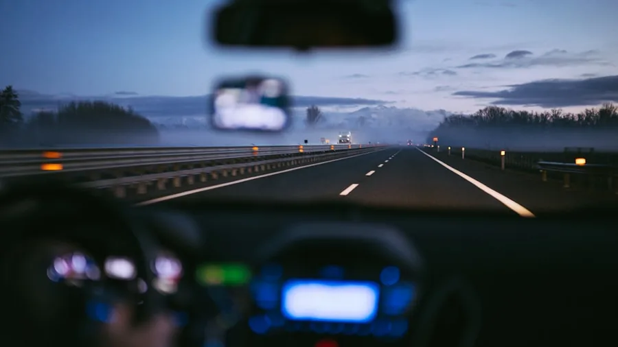 Alert driver on multi-lane highway checking speedometer while driving