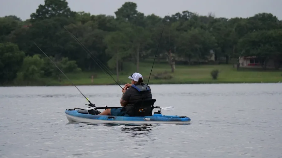 The %product_count% Best Fishing Kayaks 2 Angler sitting on kayak in calm water during daytime fishing trip