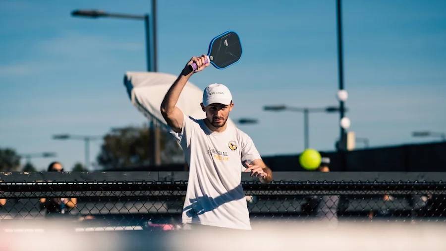 Athlete carrying sports gear bag between outdoor courts