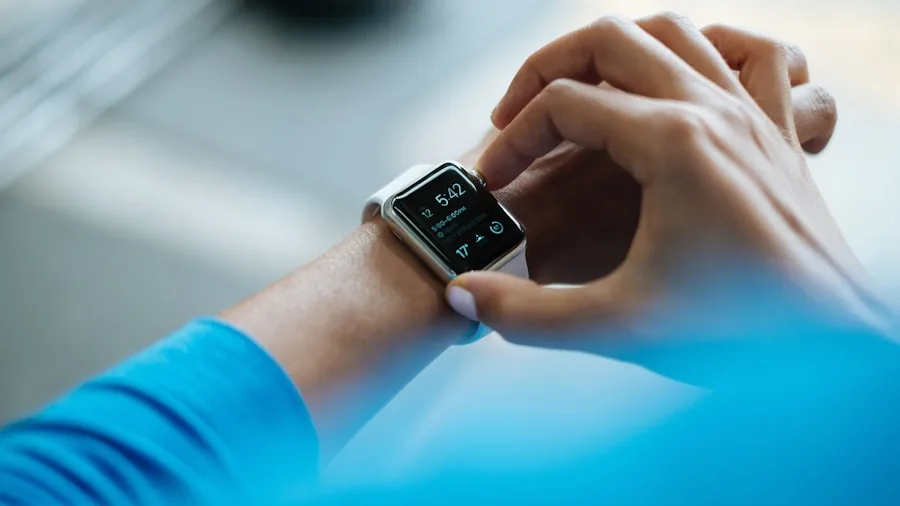 Athlete checking performance metrics on digital display during workout