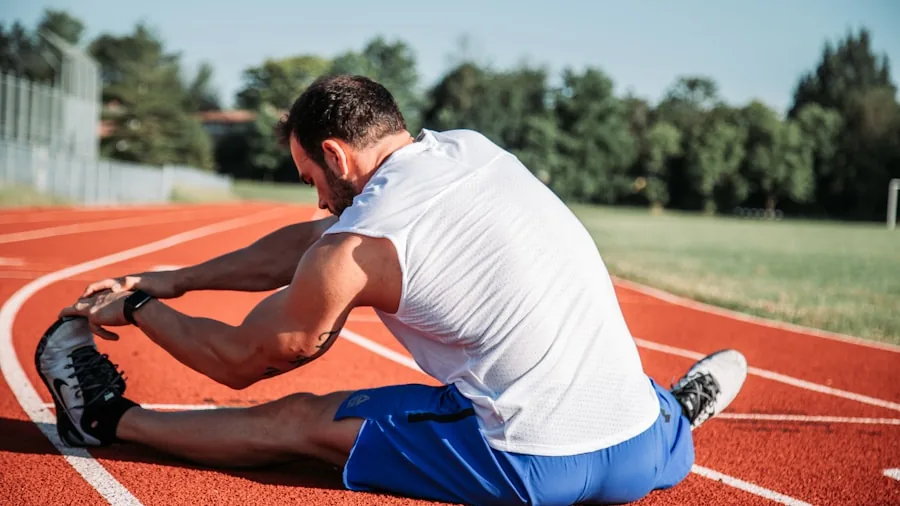 Athlete massaging sore leg muscle after intense workout training session