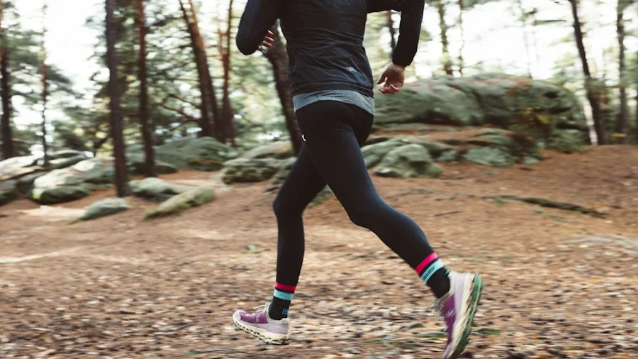 5 Hill Workout Routines to Prepare for Steep Mountain Hikes 2 athlete running uphill on forest trail