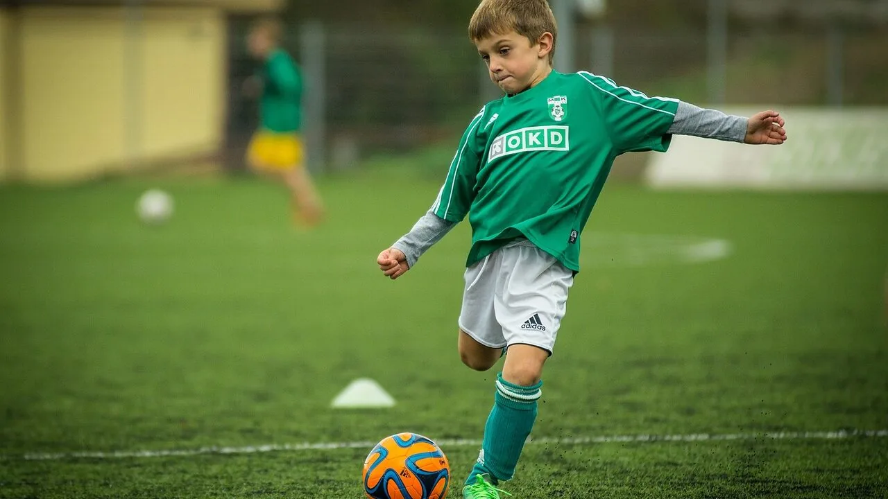 Athlete wearing football gloves catching football during game practice