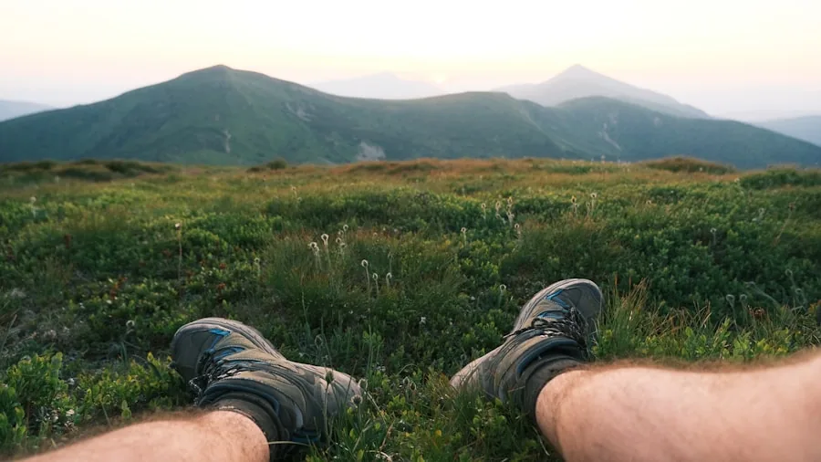 Backpacker wearing hiking boots walking on rocky mountain trail during outdoor adventure