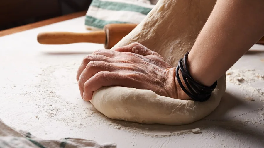 The %product_count% Best Baking Sheets 2 Baker's hands working with dough on a kitchen counter during baking preparation