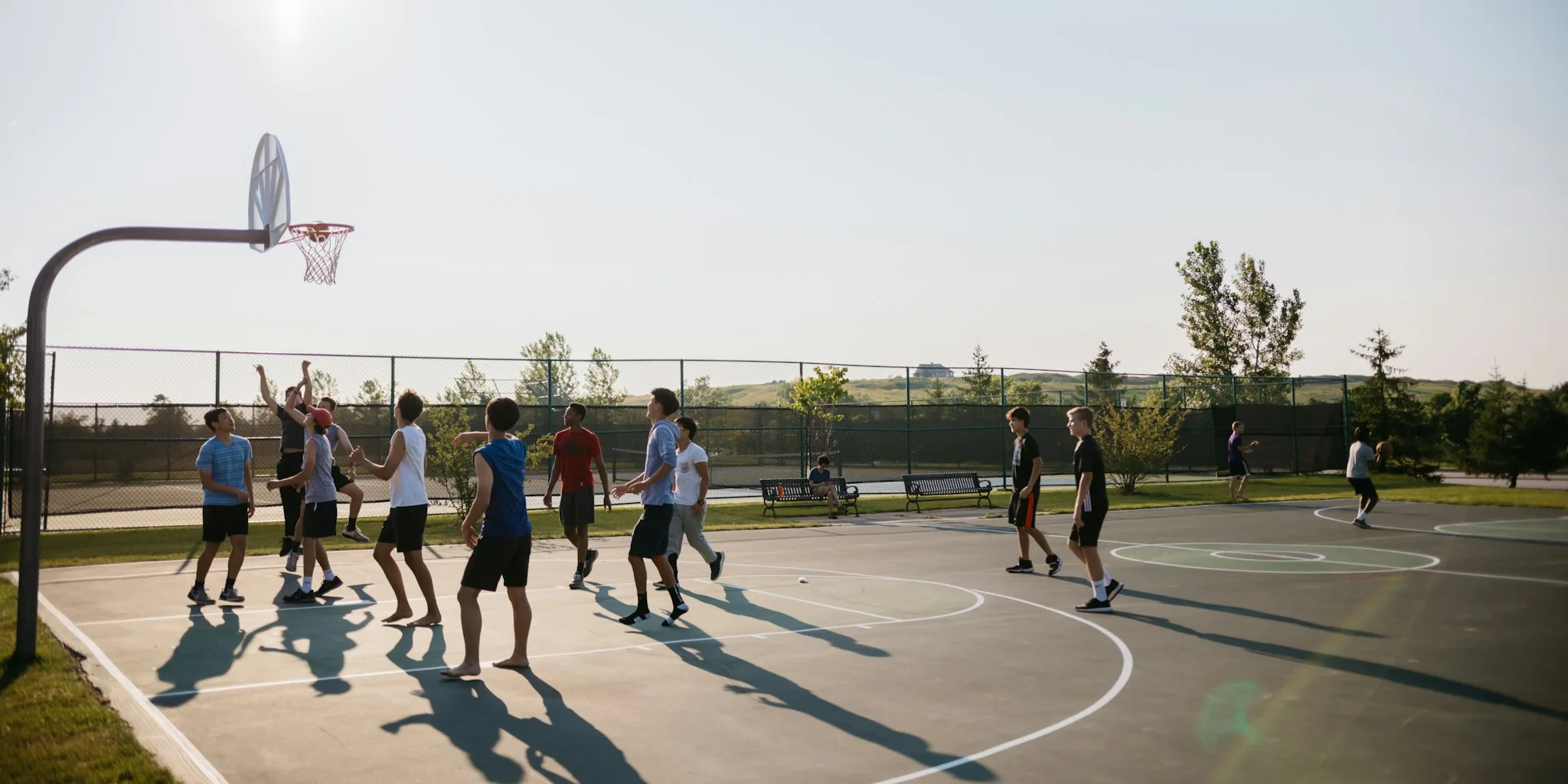 Beginner pickleball players enjoying a match on an outdoor court on a sunny day