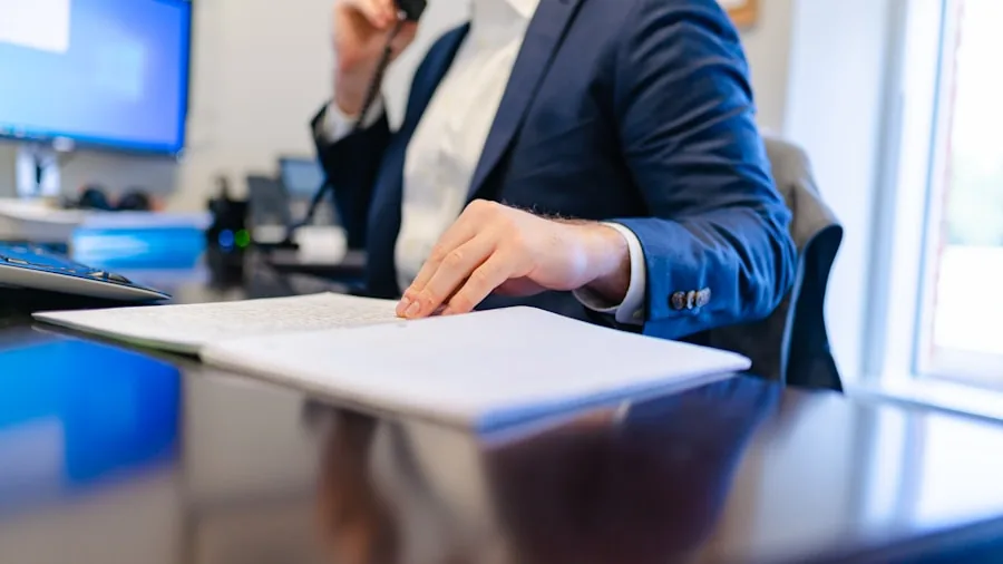 Business professional focused on work at desk during busy workday