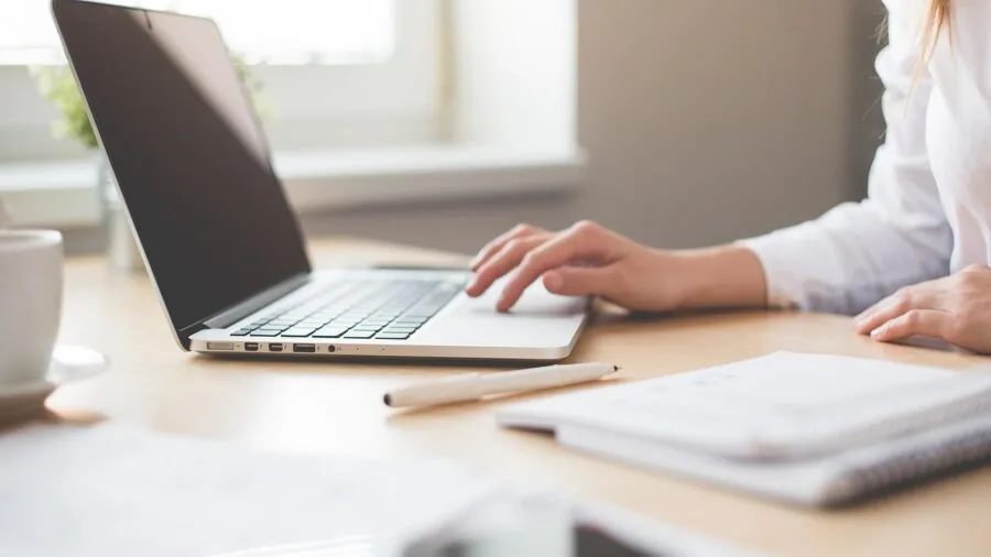 Business professional working at organized office desk with focused concentration