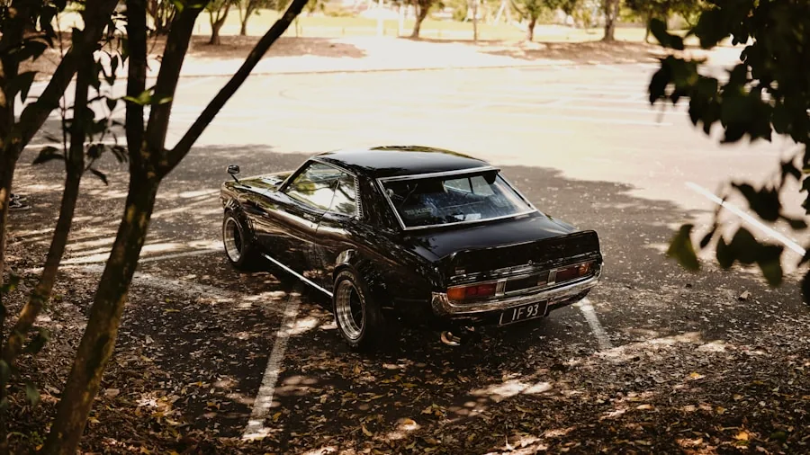 Car exposed to sun and elements in outdoor parking lot, showing need for protective covering