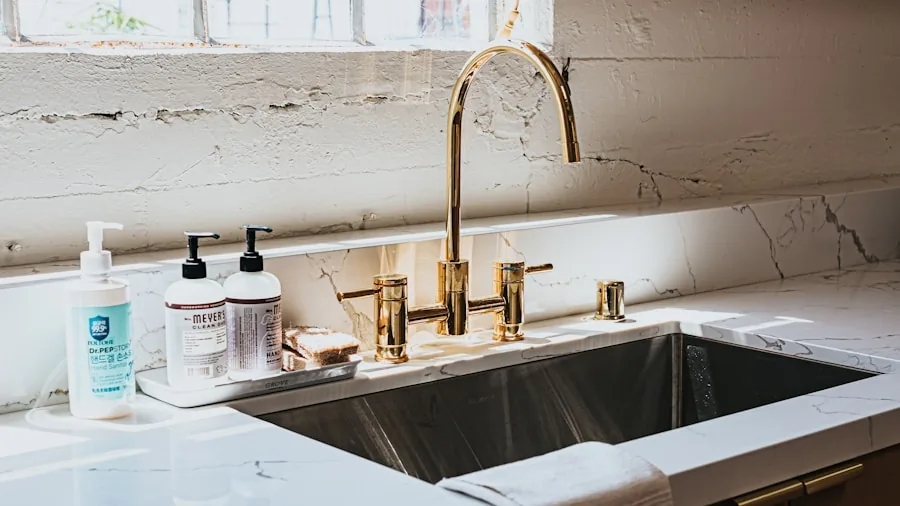 Close-up of a brass kitchen faucet installed in a contemporary home kitchen sink with natural lighting