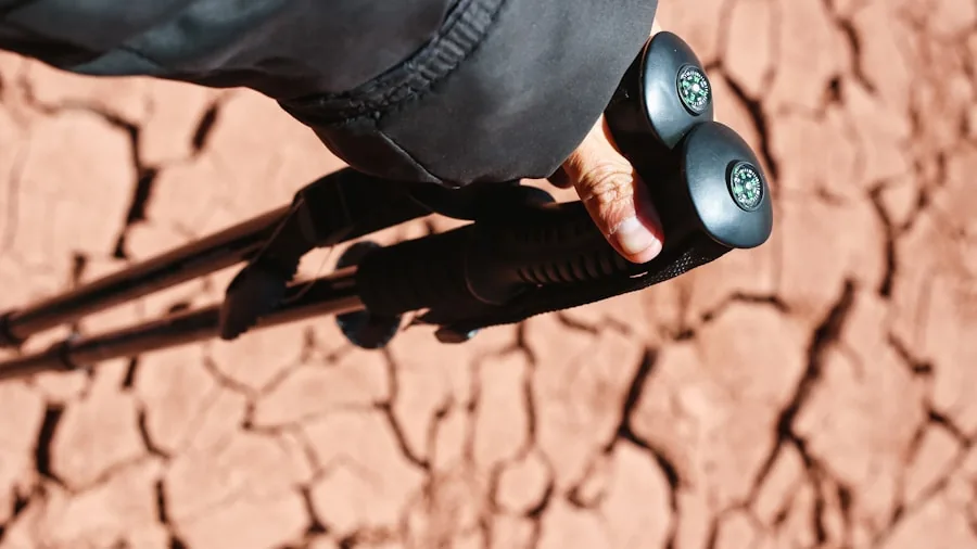 Close-up of a hiker's hand gripping a trekking pole during a mountain trail hike