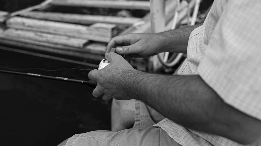 Close-up of angler inspecting fishing hook point and sharpness during pike fishing preparation