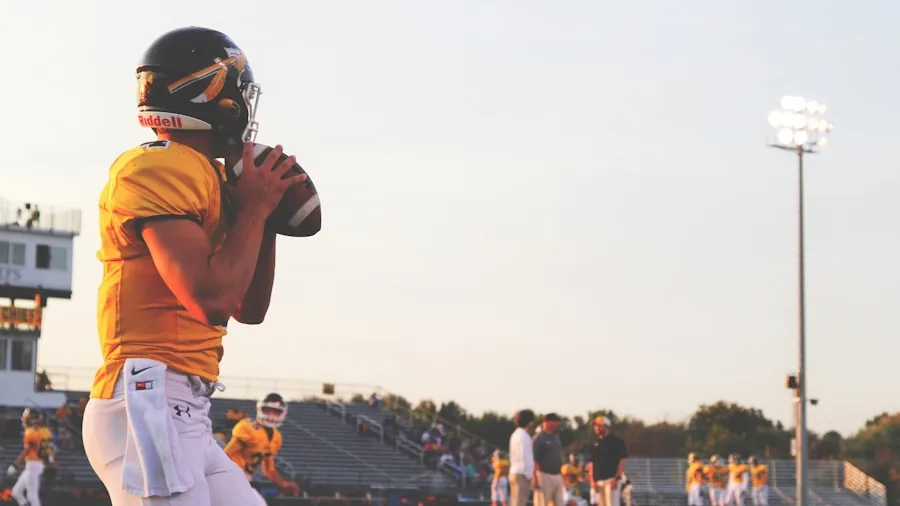 Close-up of athlete's hands making a football catch during intense game action