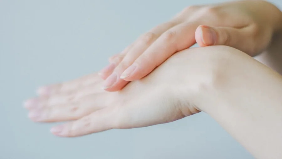 Close-up of climber examining hands and skin condition after training session