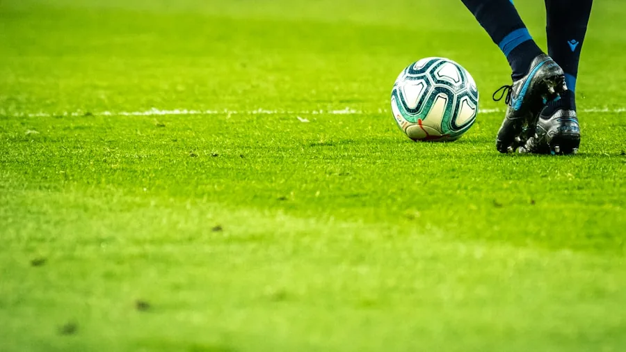 Close-up of football cleats on natural grass field during training
