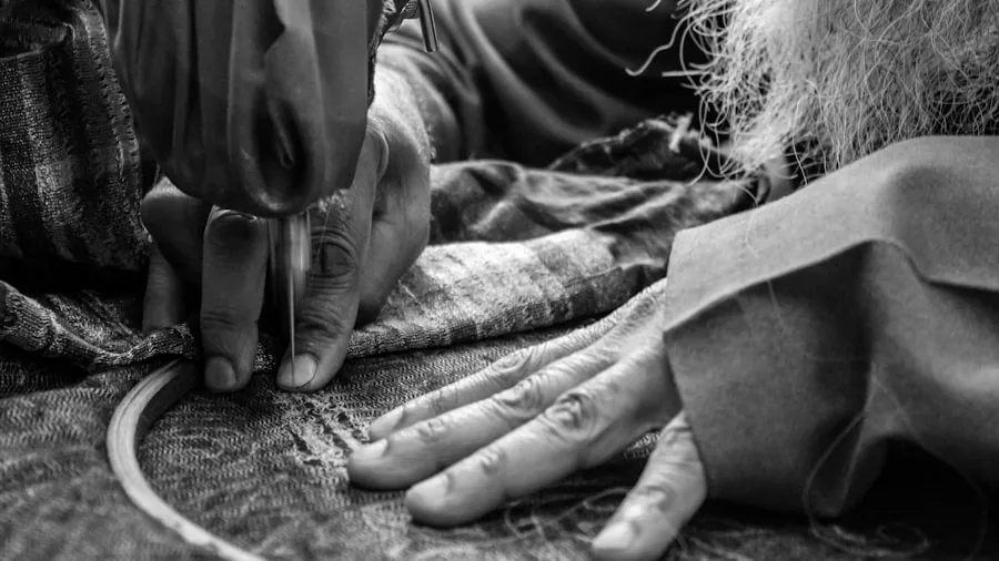 The %product_count% Best Steering Wheel Covers 4 Close-up of hands examining reinforced stitching on fabric material for quality assessment