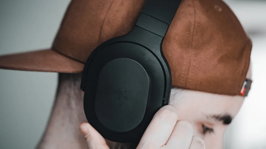 Close-up of hands inspecting premium headphone construction and durability details