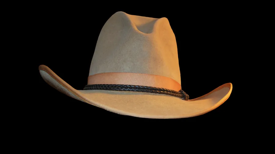 Close-up of hands inspecting quality felt cowboy hat texture and craftsmanship