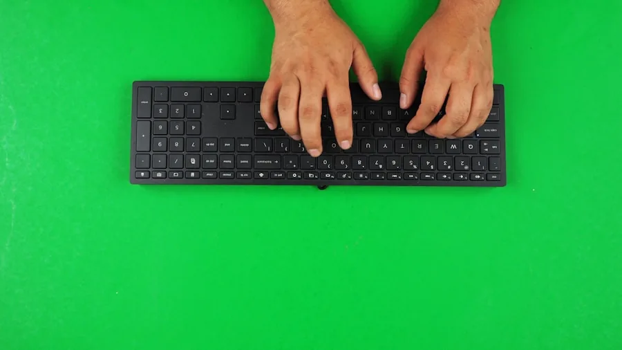 The %product_count% Best Gaming Keyboards 3 Close-up of hands typing on a mechanical keyboard at a wooden desk during work