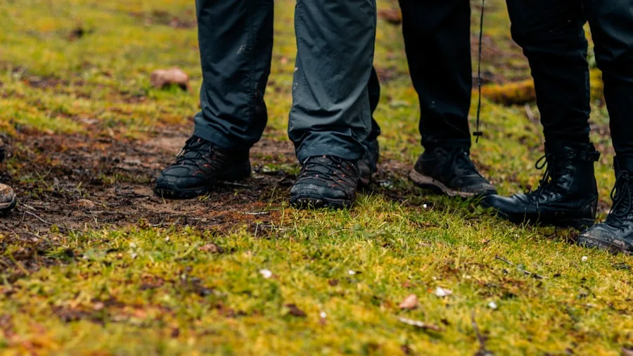 Close-up of hiking boot tread gripping wet muddy ground on forest trail