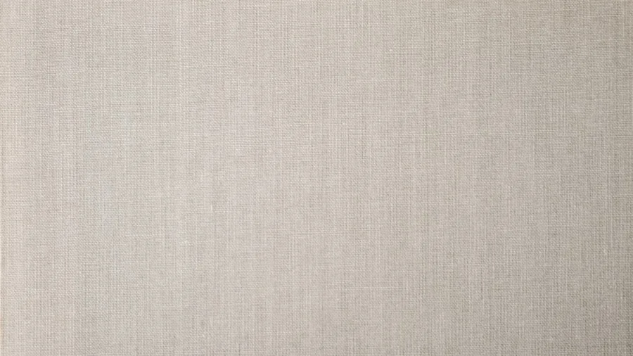 The 12 Best Curtains 2 Close-up of natural linen fabric showing texture and weave quality in natural lighting