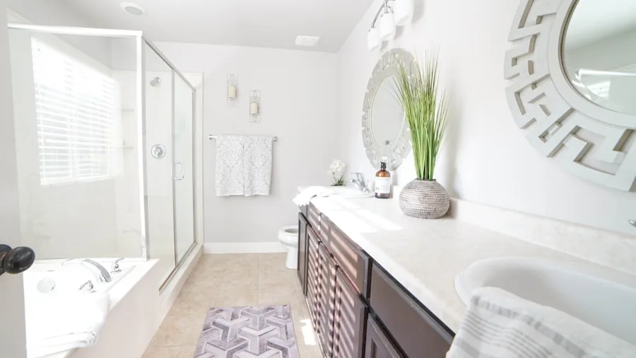 Close-up of plush chenille bath mat texture showing soft fibers and water absorption in modern bathroom