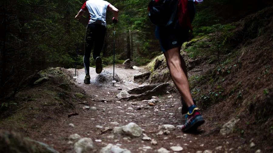 Close-up of runner's shoes gripping muddy trail surface during outdoor run