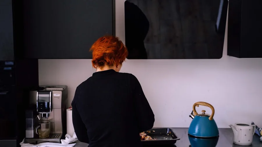 Close-up of someone's hand adjusting microwave controls in a home kitchen setting