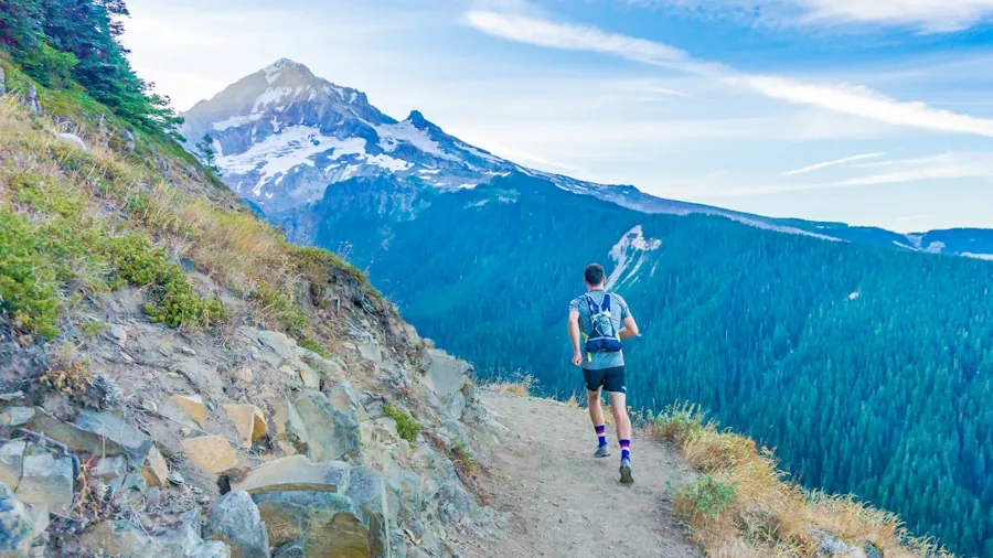 Close-up of trail runner's feet on rocky mountain descent during outdoor run