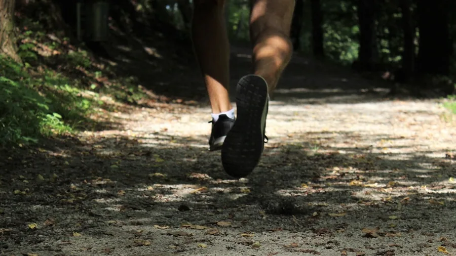 Close-up of trail runner's feet on rocky mountain path during outdoor run