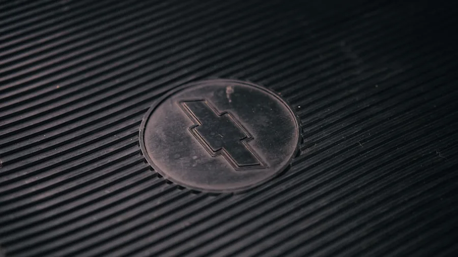 Close-up of water droplets on textured car floor mat showing liquid containment and drainage design
