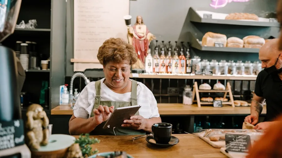La Marzocco Launches Sistema Fleet Monitoring Platform: What Espresso Shop Owners Should Know 3 coffee shop owner reviewing data tablet