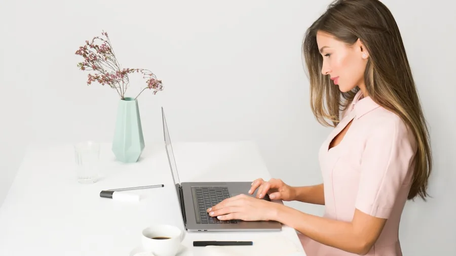 The %product_count% Best Laptops for Colleges 6 College student focused on laptop work at desk with notebook and study materials