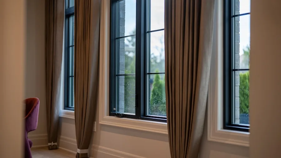 The 12 Best Curtains 4 Contemporary living room with elegantly hung curtains on metal rod hardware