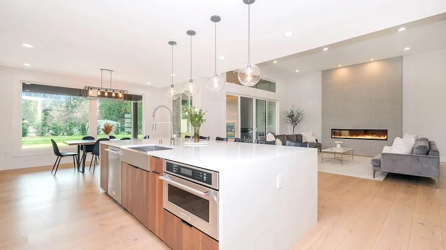 Contemporary open-plan kitchen and living area with natural light and modern appliances