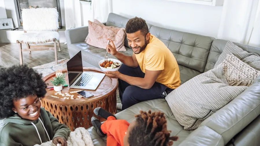 couch family watching television together