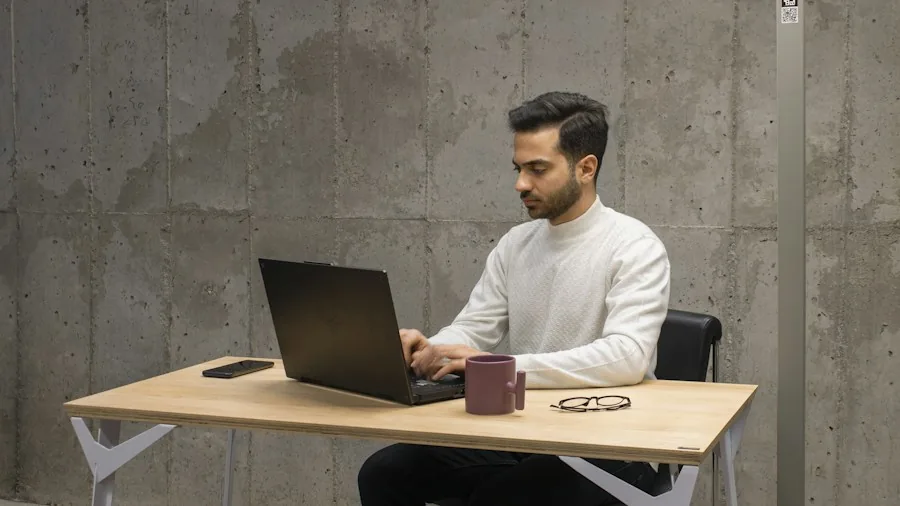 MacBook Ultra Touchscreen Laptop Coming in October What Shoppers Should Know 2 creative professional at desk with laptop