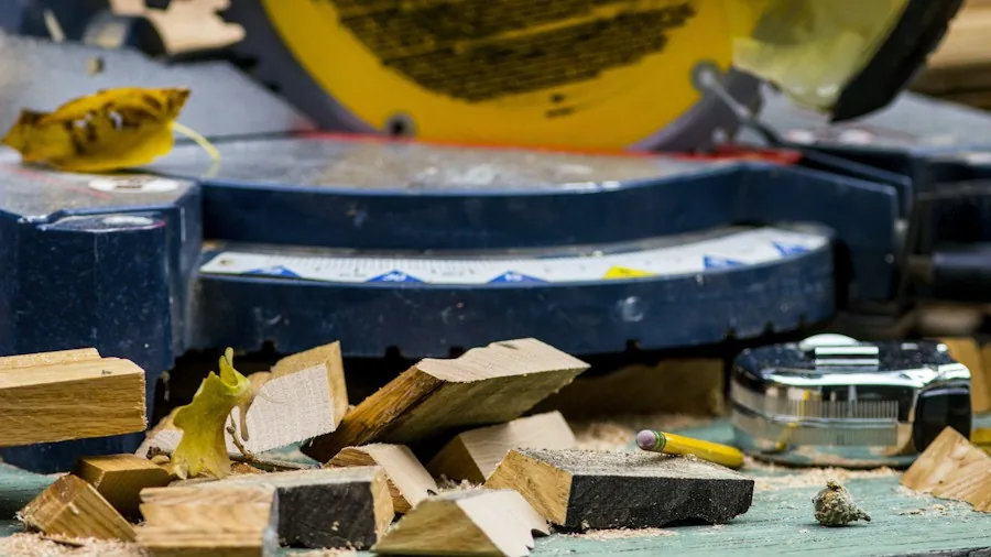 cutting lumber with miter saw closeup