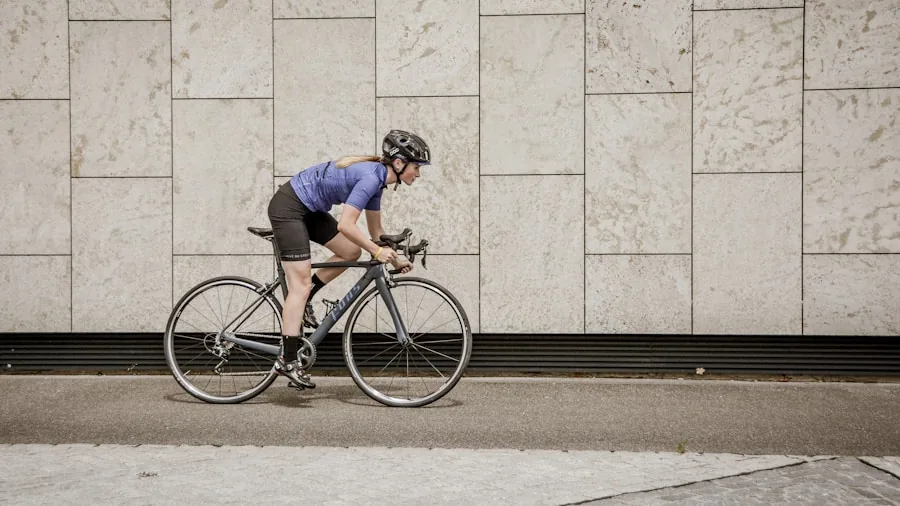 Cyclist glancing at bike computer screen while riding on road