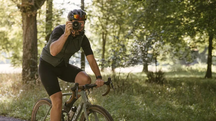 The %product_count% Best Road Bikes 3 Cyclist in casual gear adjusting their bike's drivetrain while riding on a scenic outdoor path