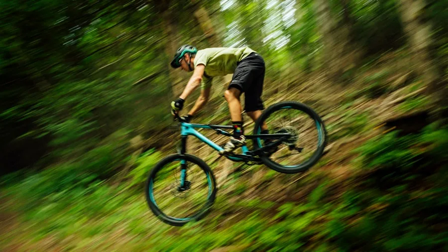 The %product_count% Best Mountain Bikes 5 Cyclist in outdoor setting adjusting mountain bike frame size and geometry for proper fit