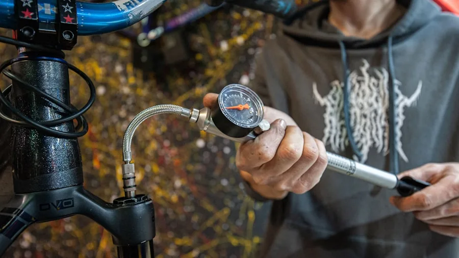 The %product_count% Best Bike Pumps 2 Cyclist inspecting bike tire pressure with gauge before ride
