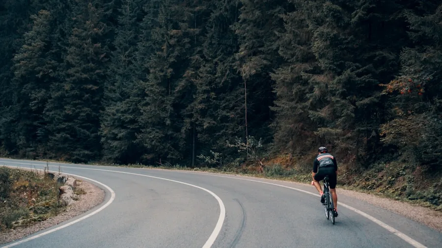Cyclist on road wearing bright helmet during evening ride with traffic visibility