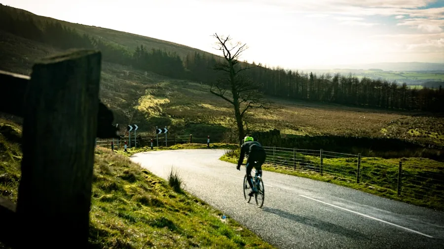Cyclist riding uphill on a scenic outdoor road, demonstrating cycling performance and endurance