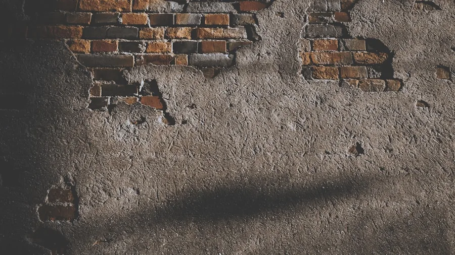 DIY homeowner using hammer drill to make hole in masonry brick wall for home renovation project
