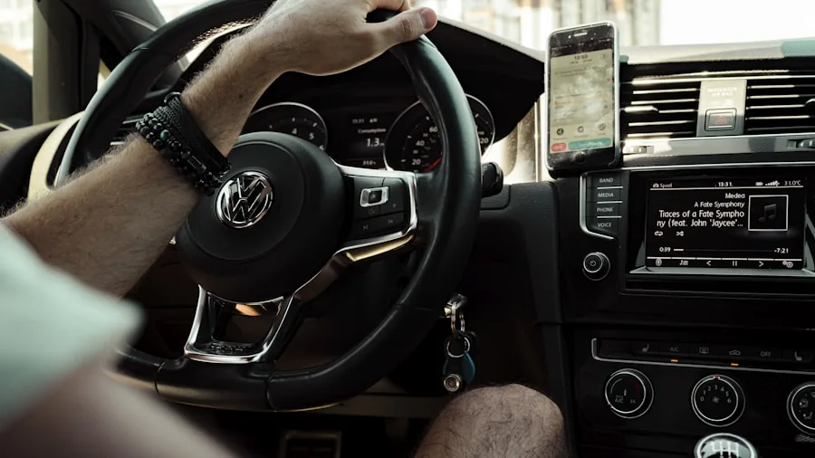 Driver adjusting smartphone mount on car dashboard while driving