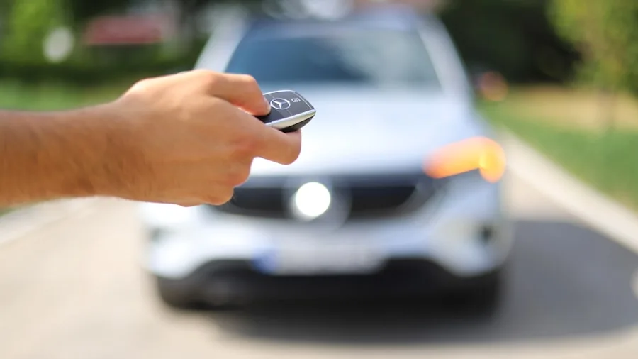 The %product_count% Best Remote Starters 3 Driver checking car starter confirmation on key fob in winter setting