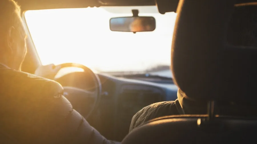 Driver's perspective through car windshield while driving on road during daytime
