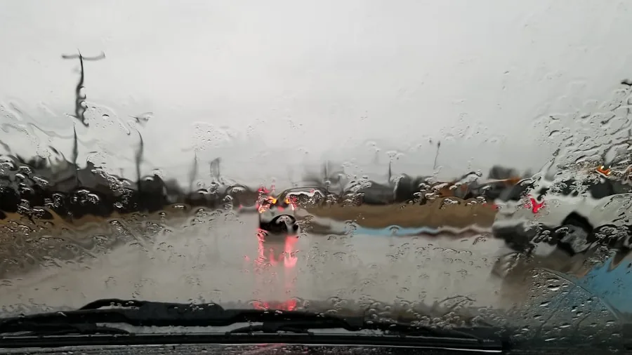 The %product_count% Best Windshield Wipers 4 Driver's view through wet windshield during heavy rainfall on highway