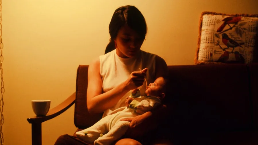 The %product_count% Best Baby Monitors 5 Exhausted parent viewing baby monitor screen during nighttime feeding